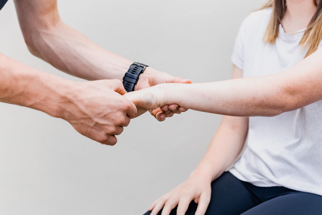 A physical therapist helping a senior patient with exercises at home.